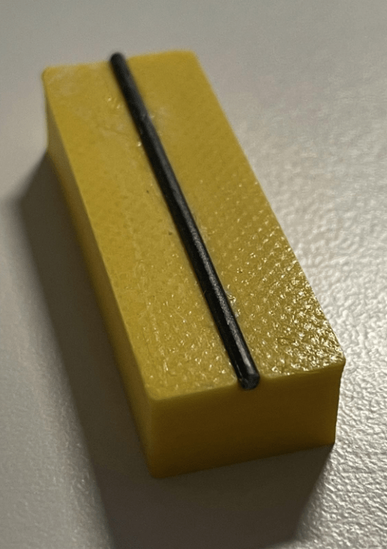 Test object using a piece of unprinted filament as a tactile line.