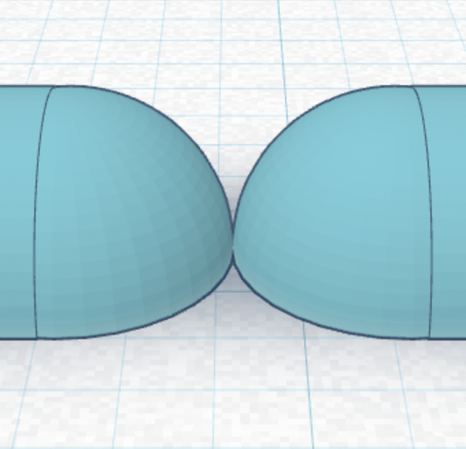 Two round shapes with a flat bottom. The peak of the round shape on the flat side is touching the other one.