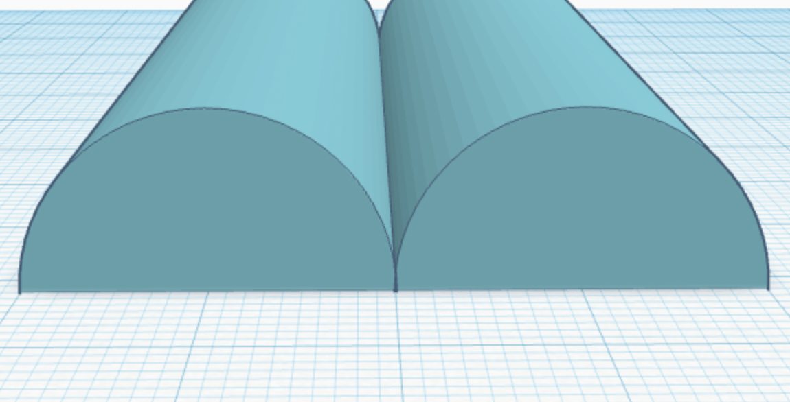 Two half cylinder with a flat bottom next to each other. The long side of the cylinder is just touching the other one.