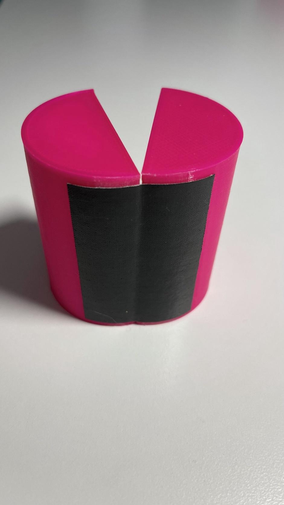 A cylinder made of two halves joined with a piece of adhesive tape (Tesa cloth tape) as a hinge.